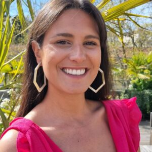 Image d’une femme souriante portant des boucles d’oreilles hexagonales en corne, ajoutant une touche unique et élégante à son look. Parfait pour les accessoires de mode tendance.